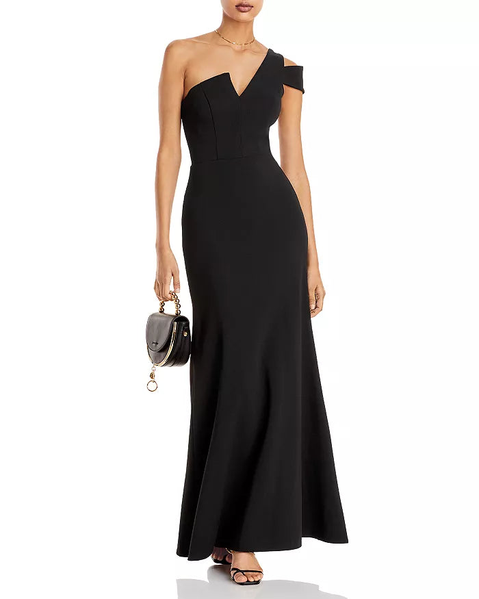 Elegante vestido de noche negro con hombros descubiertos y borde de hoja de loto hasta el suelo