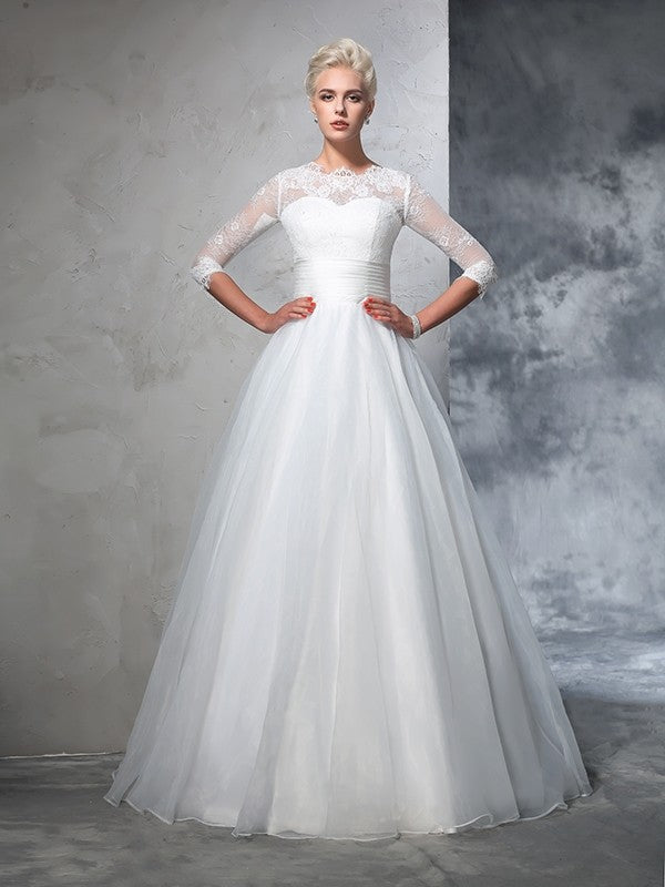 Vestidos de novia largos de organza con mangas 3/4 y apliques de joya