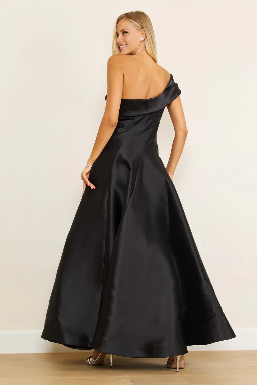Vestido de fiesta largo hasta el suelo, sin mangas, con cuello asimétrico, hombros descubiertos, detalles plisados, espalda descubierta y abertura lateral. 