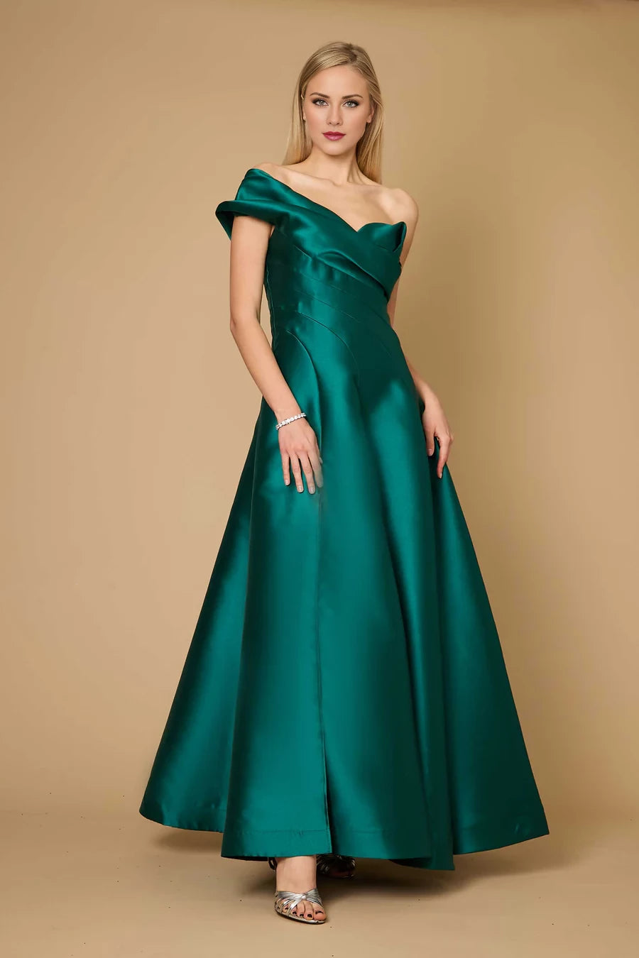 Vestido de fiesta largo hasta el suelo, sin mangas, con cuello asimétrico, hombros descubiertos, detalles plisados, espalda descubierta y abertura lateral. 
