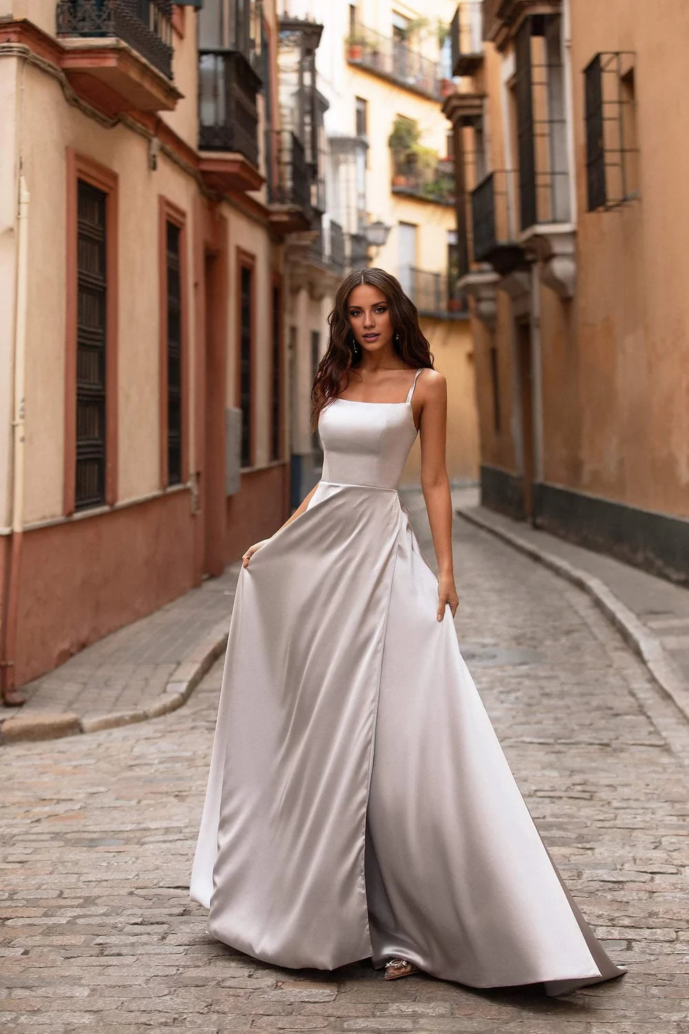 Vestido de noche largo hasta el suelo, sin mangas, con escote cuadrado, hombros descubiertos y tirantes finos. 