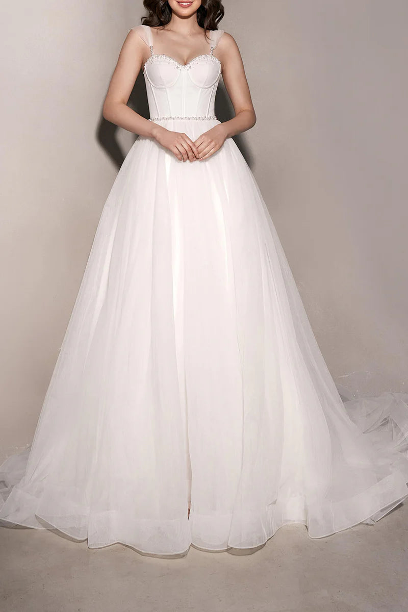 Abito da sposa minimalista trasparente con scollo a cuore e perle