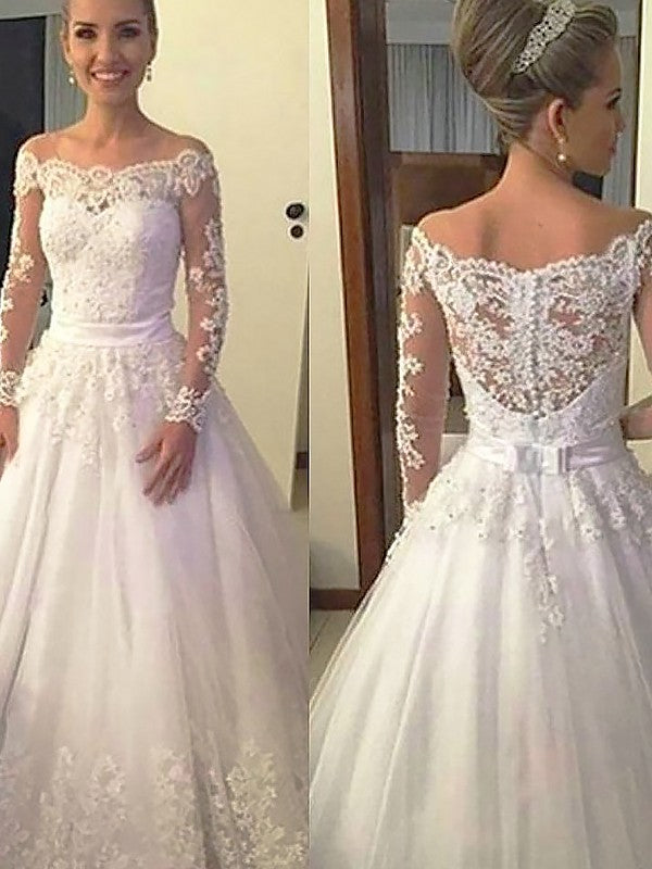 Vestidos de novia de tul con encaje y cola de corte, mangas largas y hombros descubiertos